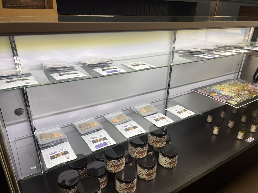 Chilla Smoke glass display case with Chilla products and Buzz Drops