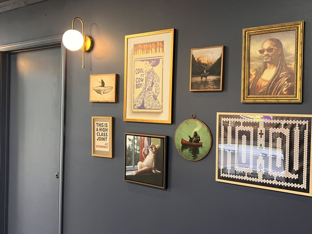 Chilla Smoke gallery wall with framed art and high-class joint sign